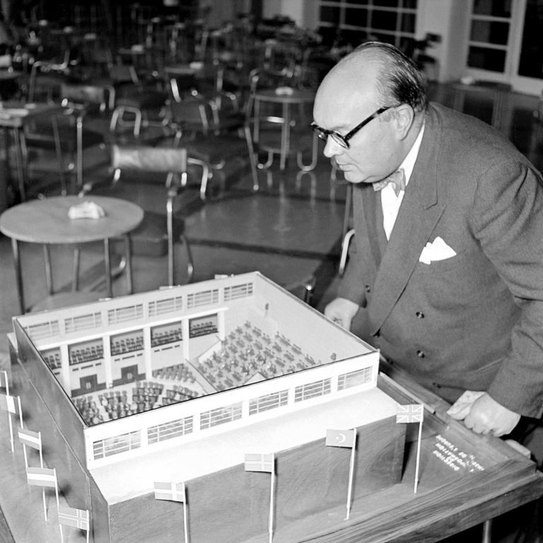 Paul-Henri Spaak in front of the model of the Consultative Assembly of the Council of Europe